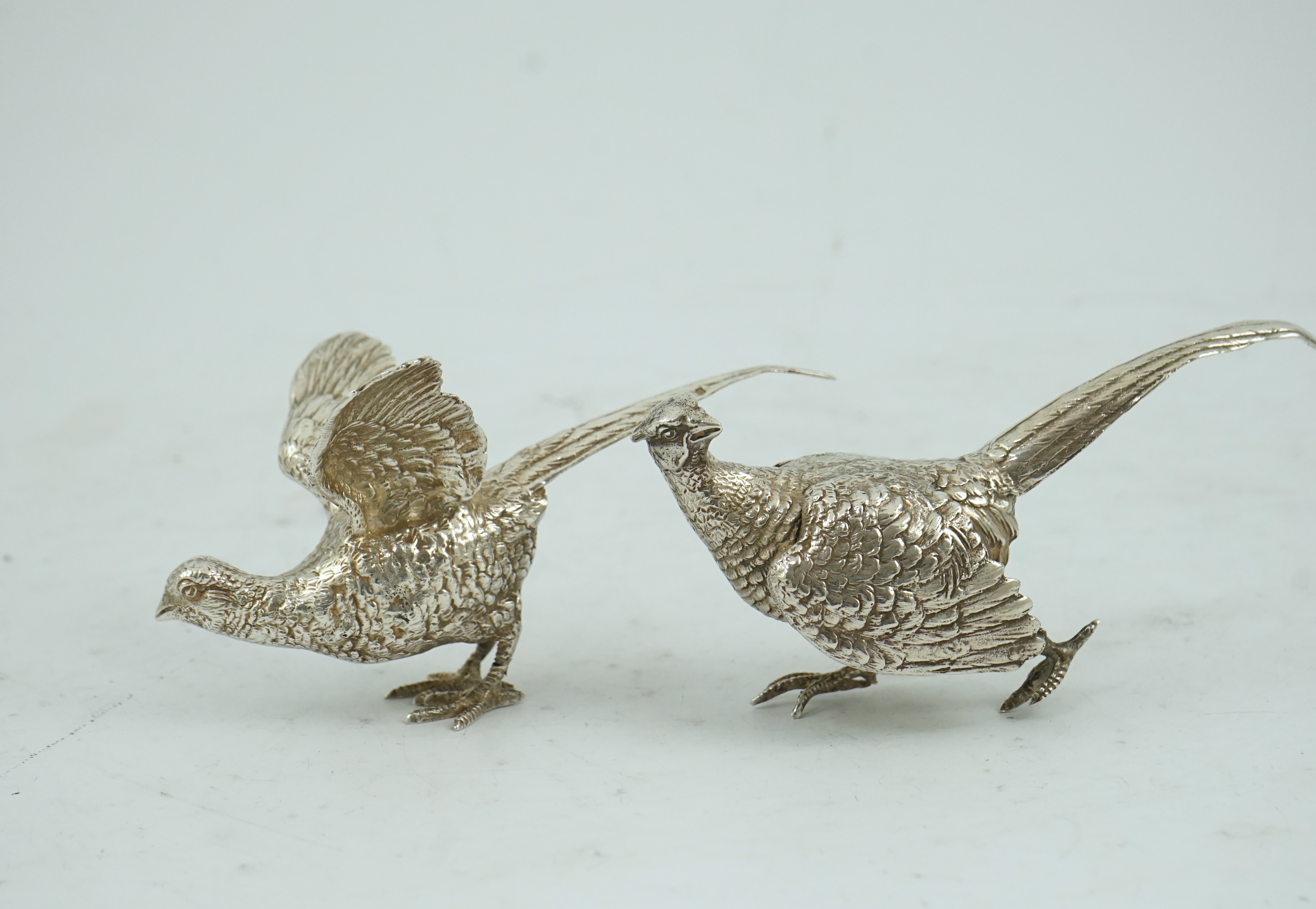 A pair of Elizabeth II silver free-standing model pheasants, by Edward Barnard & Sons Ltd